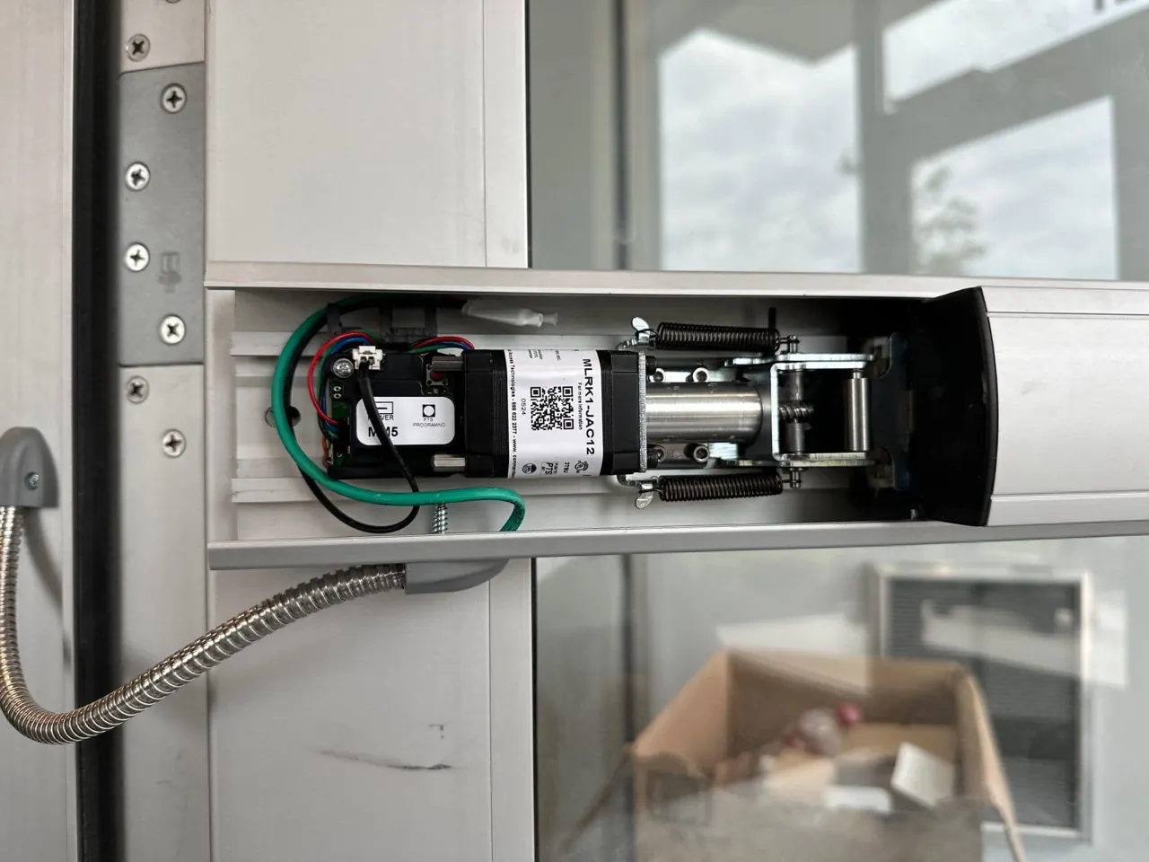 Electrified exit hardware mechanism installed inside commercial door assembly