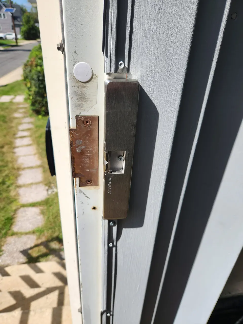 Surface-mounted electric strike installed on commercial door frame