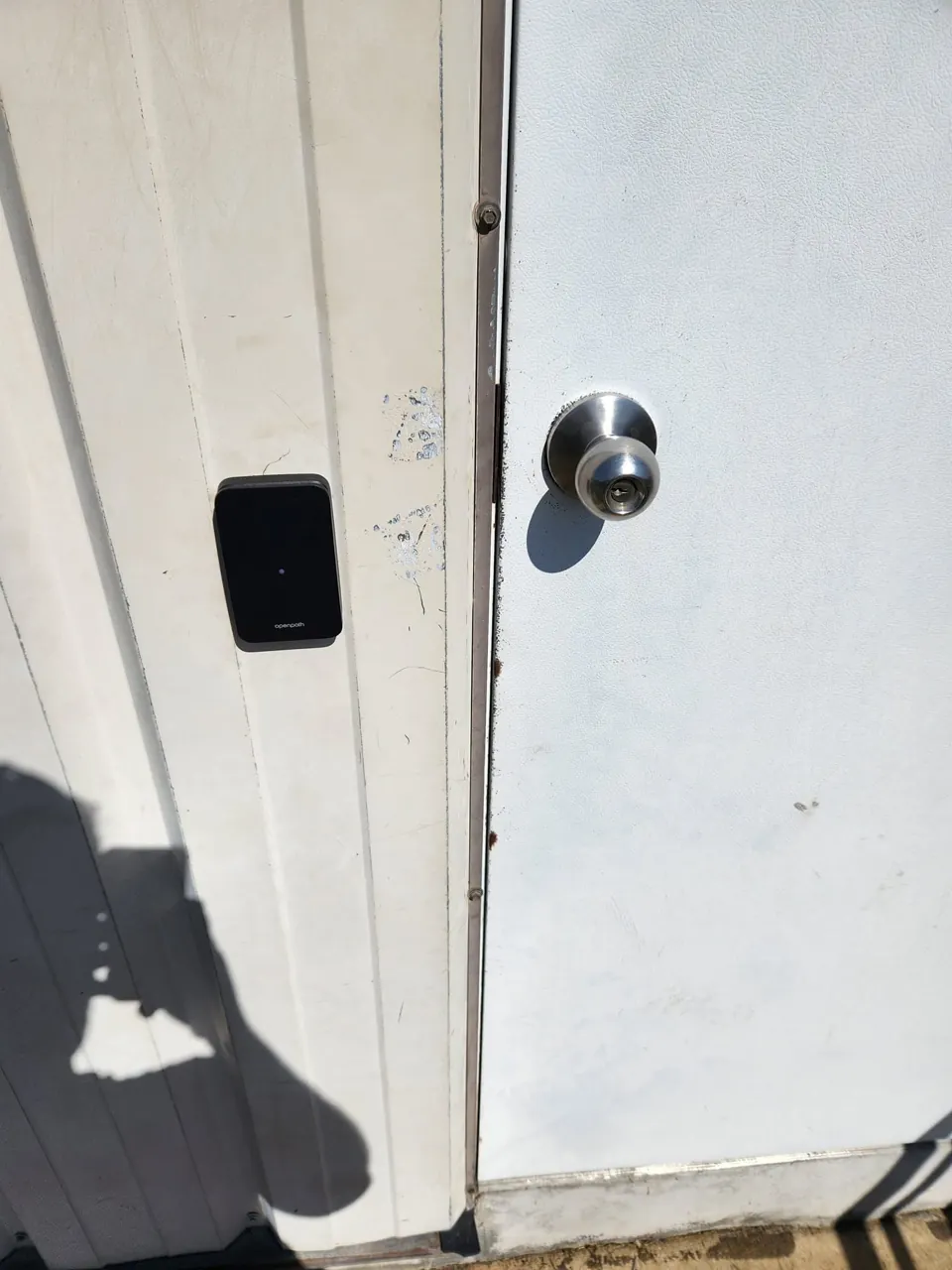 Exterior Openpath credential reader beside commercial door