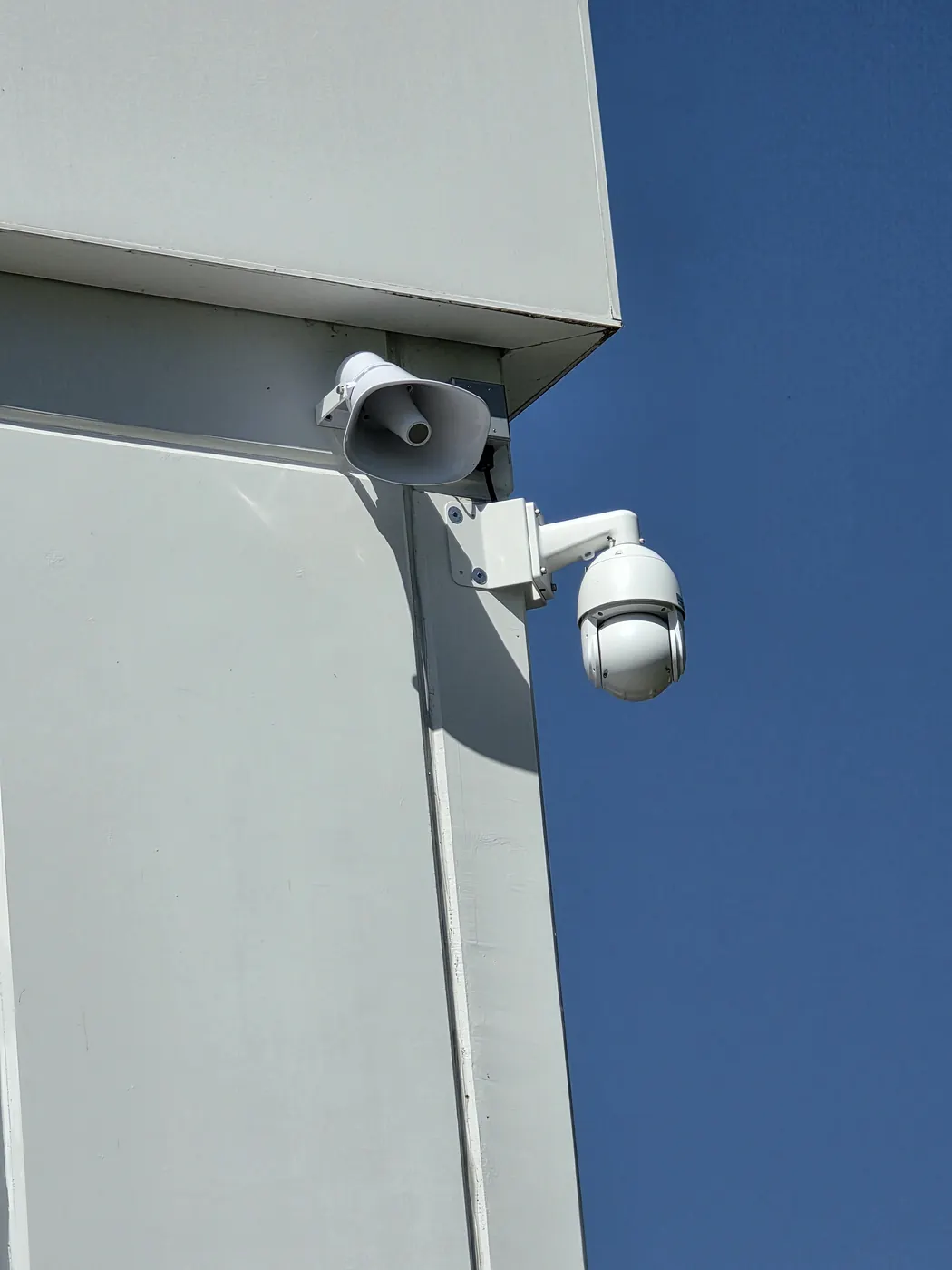 Wide view of a PTZ surveillance camera installed on a commercial building exterior