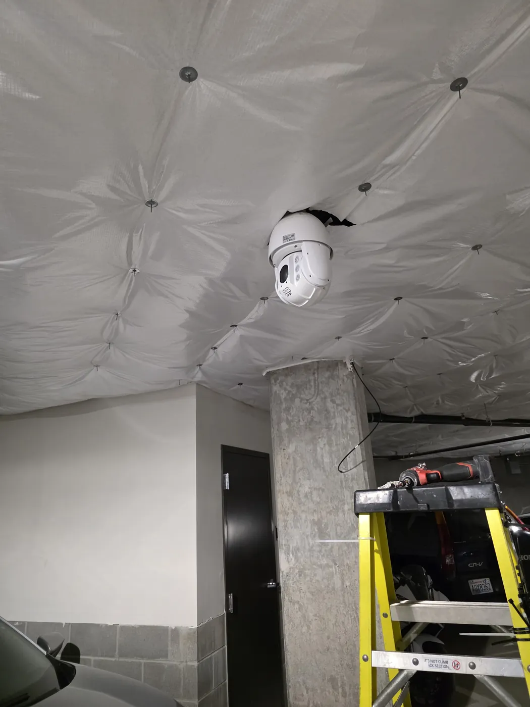 Indoor security camera mounted near an elevated commercial work area