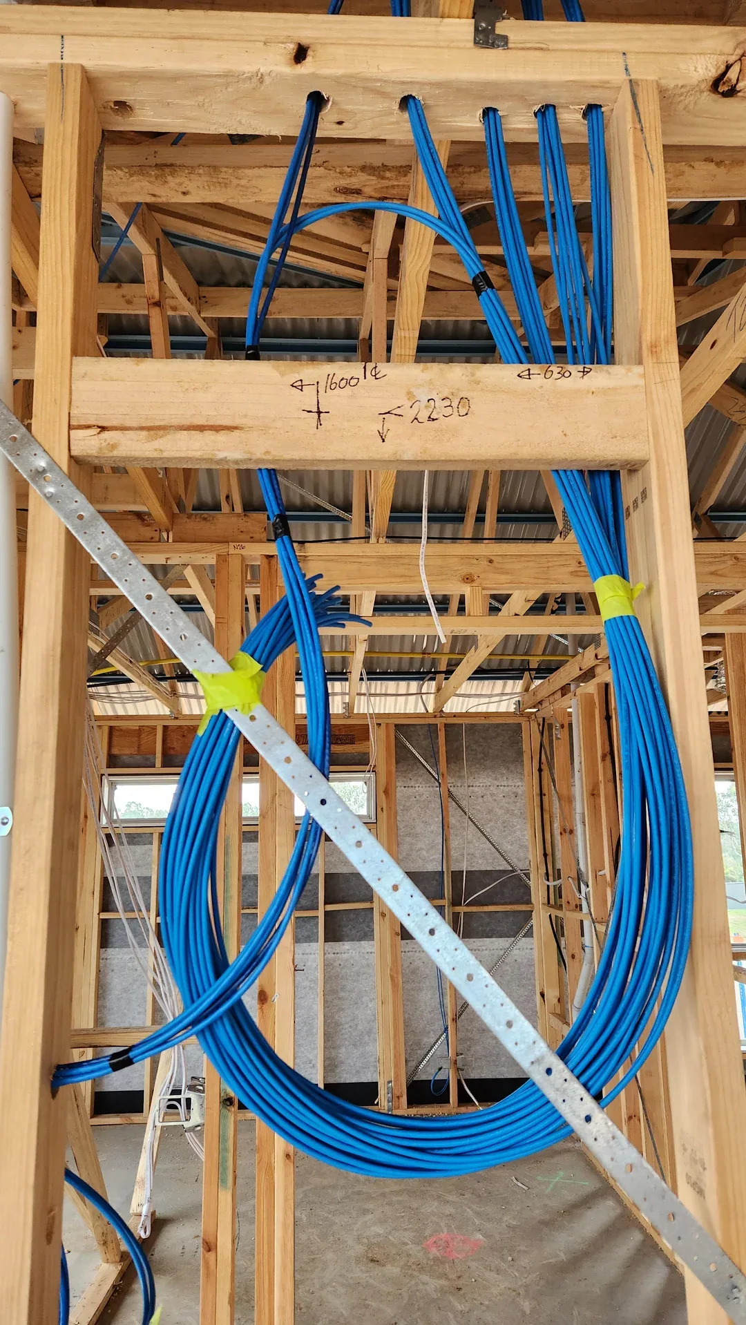 Low-voltage cable rough-in during new construction before drywall
