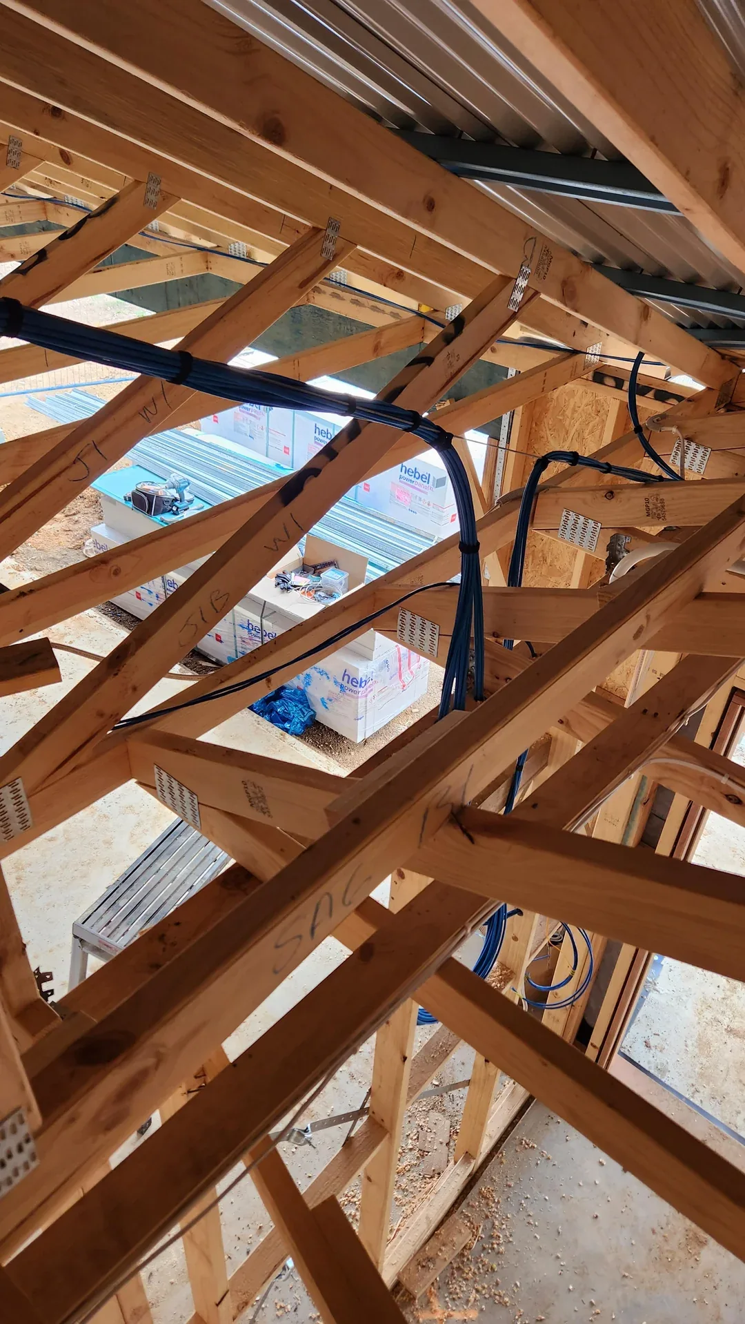 Low-voltage cable bundle secured along open roof trusses