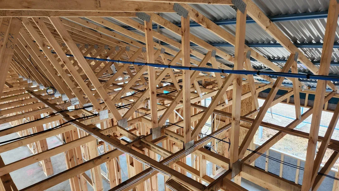 Overhead cable runs across framed roof structure