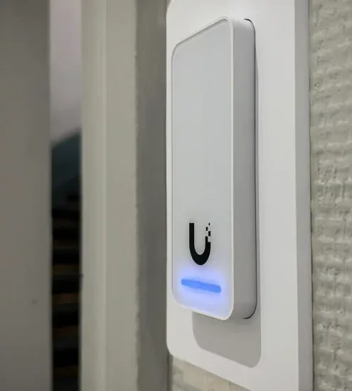 White UniFi Access reader mounted beside door